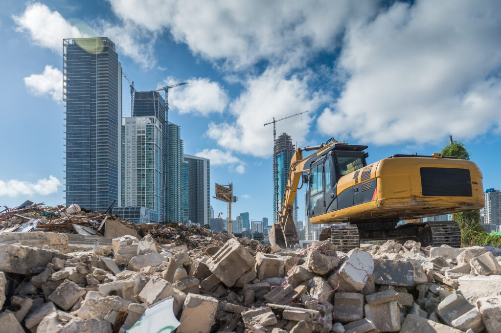 Excavator carrying out a commercial demolition against the Toronto skyline