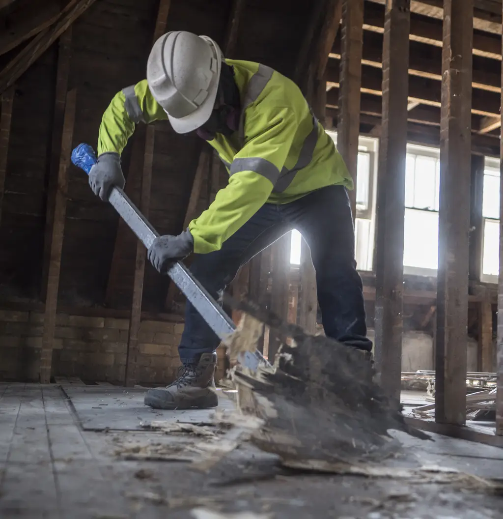 MAGCOR worker clearing demolition debris by hand